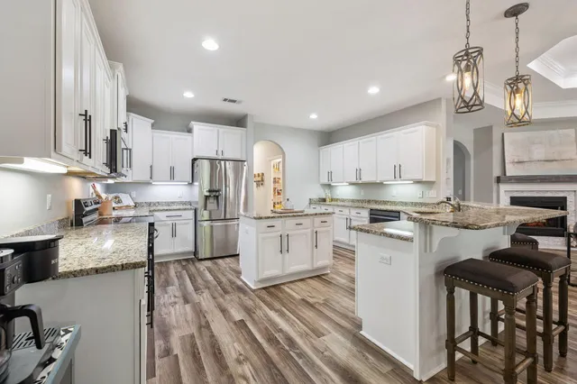 a kitchen with white cabinets and stainless steel appliances