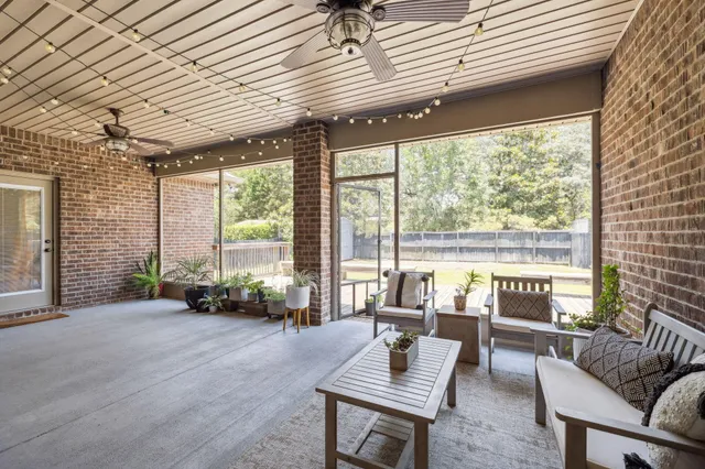 a living room with furniture and large windows