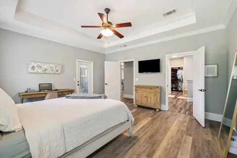 a bedroom with a bed and a flat screen tv