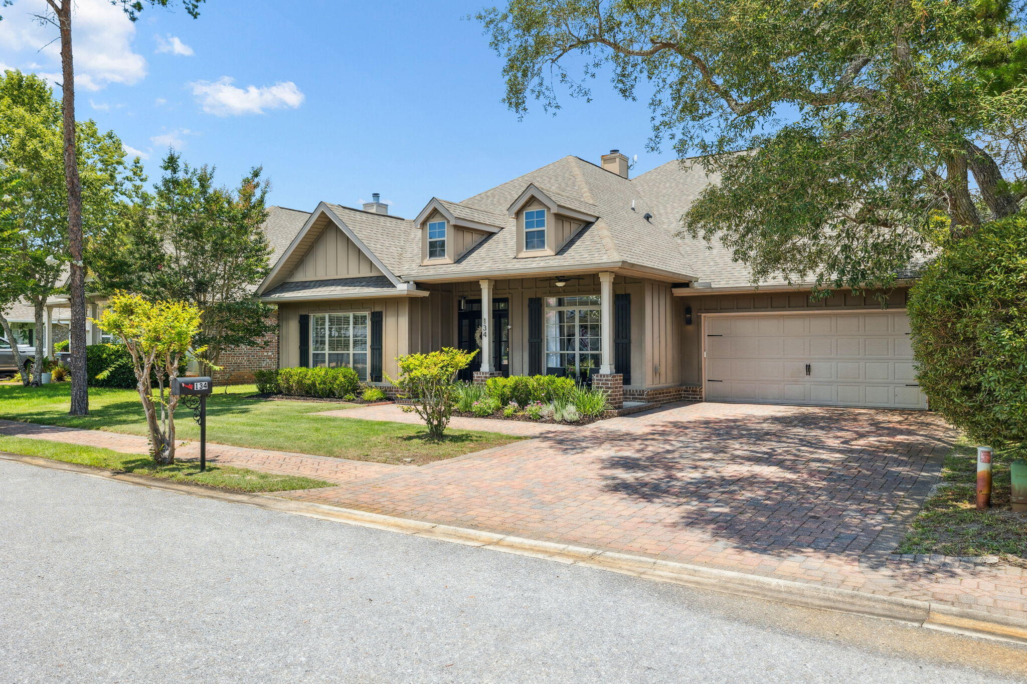 134 Mussett Bayou Court Santa Rosa Beach, FL 32459 - Photo 2 of 41 a front view of a house with a garden and trees