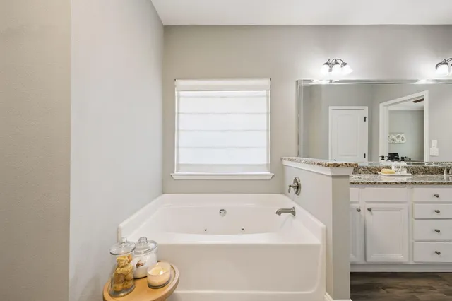 a bathroom with a bathtub and a sink