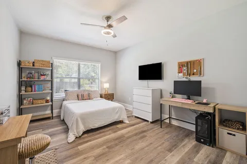 a bedroom with a bed and a flat screen tv