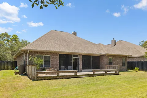 a view of a house with swimming pool and a porch with furniture