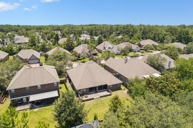 an aerial view of a house with a yard basket ball court and outdoor seating