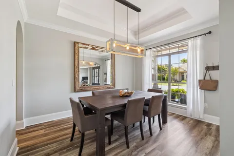 a dining room with furniture window wooden floor