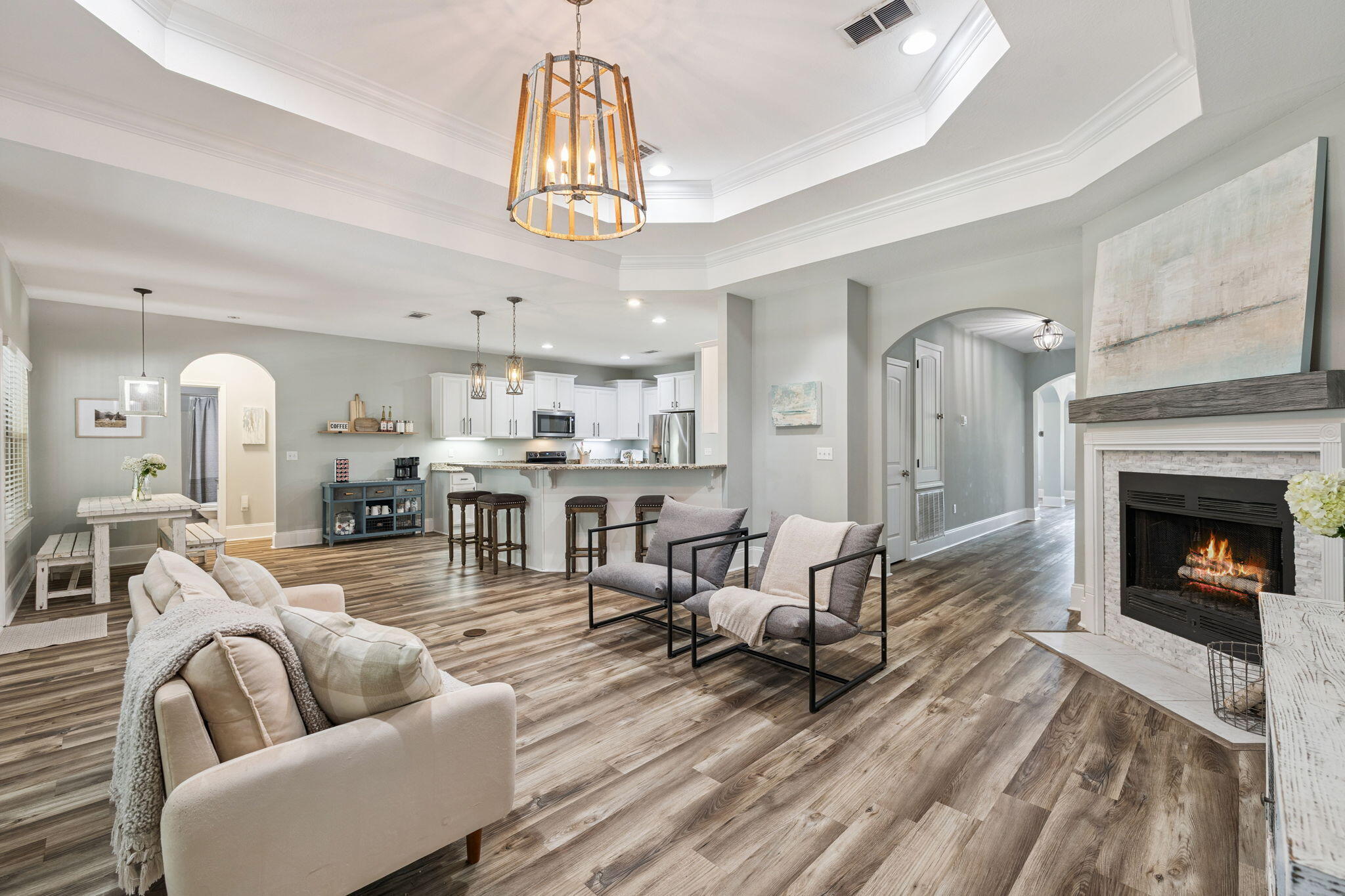 134 Mussett Bayou Court Santa Rosa Beach, FL 32459 - Photo 7 of 41 a living room with furniture a fireplace and a chandelier
