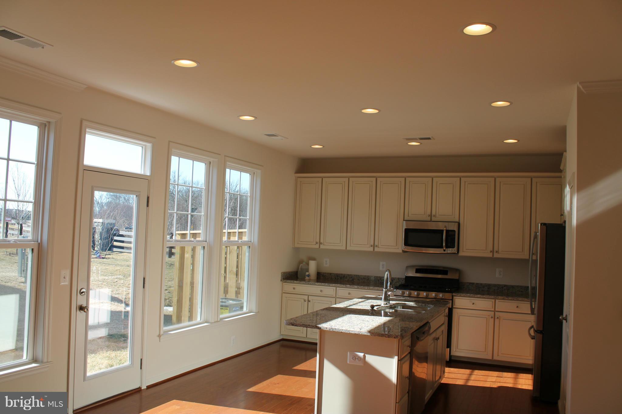 22017 Millwick Terrace Ashburn, VA 20148 - Photo 1 of 19 a kitchen with stainless steel appliances granite countertop a refrigerator and a stove top oven