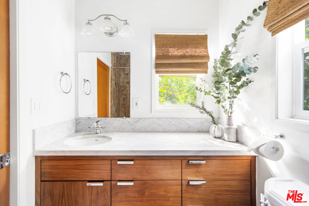 1715 Sinaloa Avenue Pasadena, CA 91104 - Photo 18 of 33 a bathroom with a sink and a mirror