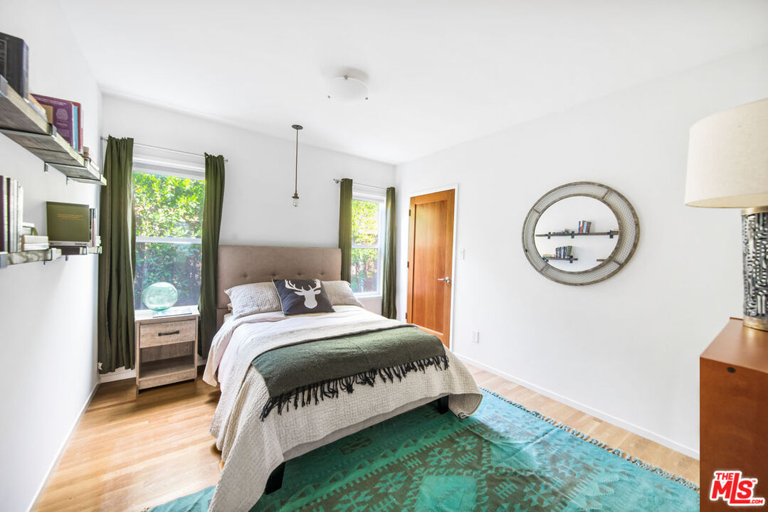 1715 Sinaloa Avenue Pasadena, CA 91104 - Photo 23 of 33 a bedroom with a bed a mirror and a window