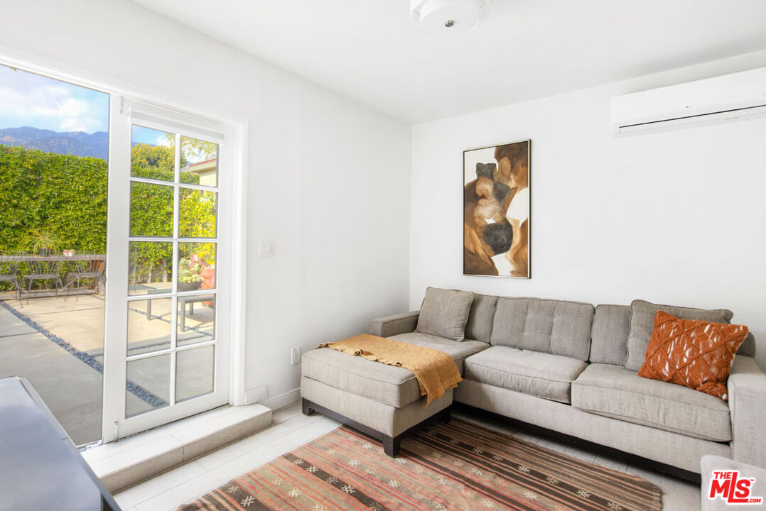 1715 Sinaloa Avenue Pasadena, CA 91104 - Photo 25 of 33 a white couch sitting in a living room with a couch and a window