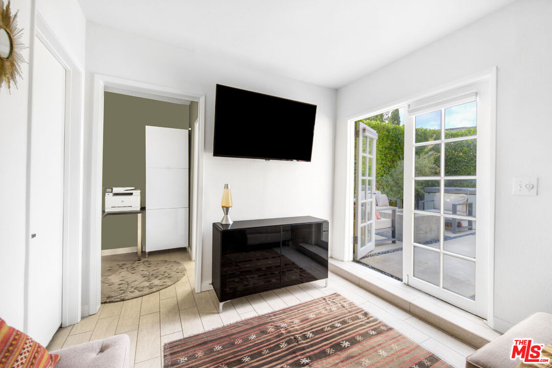 1715 Sinaloa Avenue Pasadena, CA 91104 - Photo 26 of 33 a living room with a flat screen tv and a glass door
