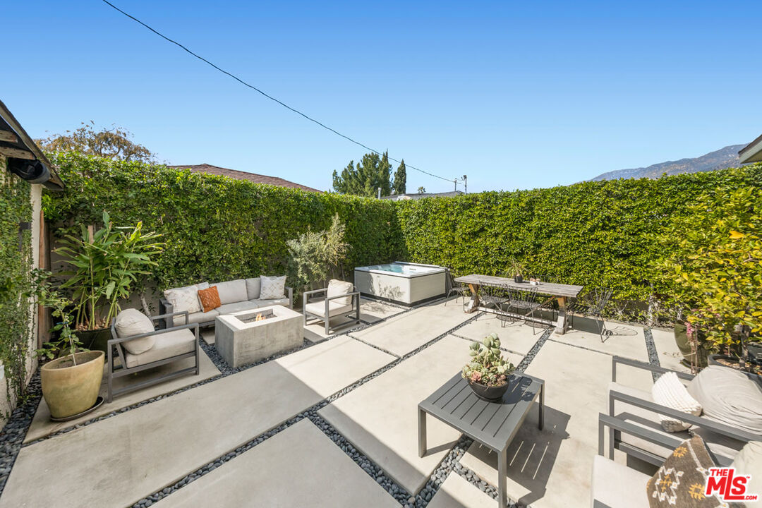 1715 Sinaloa Avenue Pasadena, CA 91104 - Photo 27 of 33 a view of a patio with couches table and chairs with potted plants and mountain view