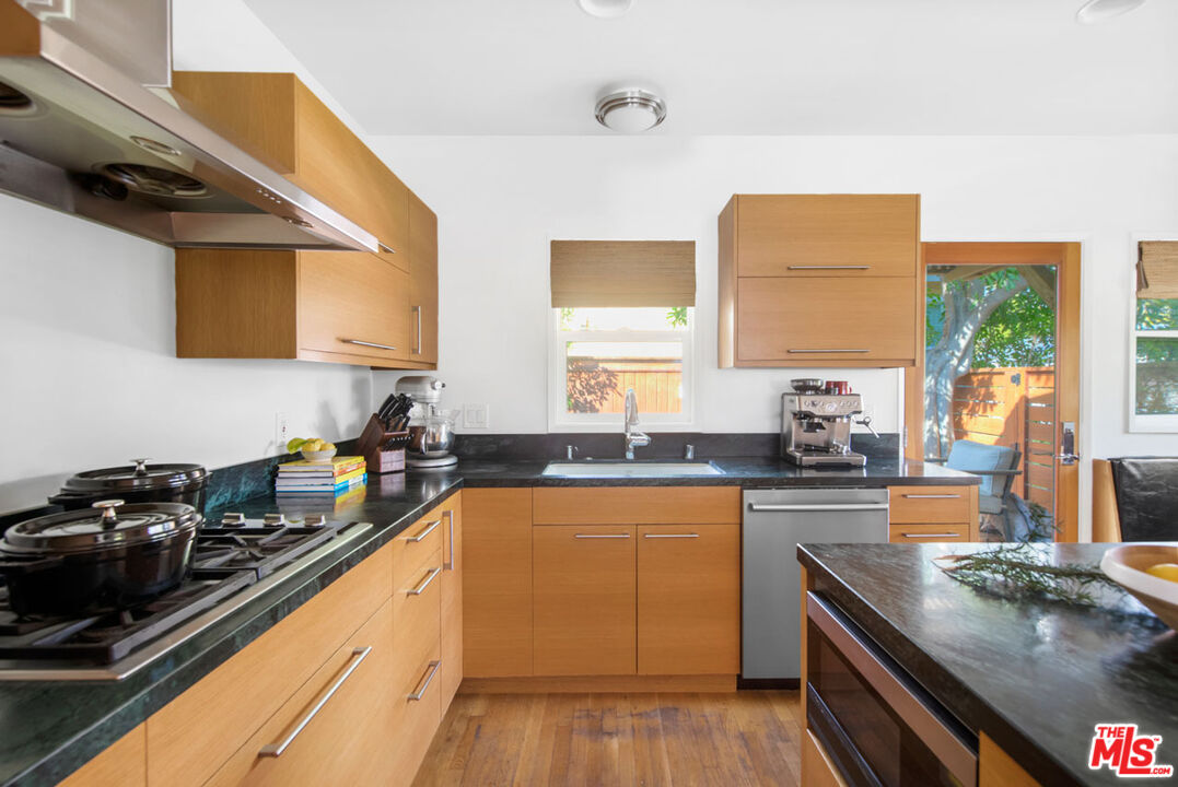 1715 Sinaloa Avenue Pasadena, CA 91104 - Photo 10 of 33 a kitchen with stainless steel appliances a sink dishwasher stove and oven