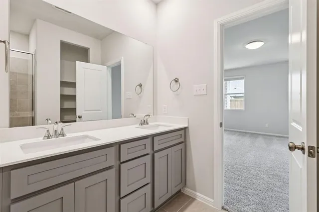 a bathroom with a double vanity sink mirror and