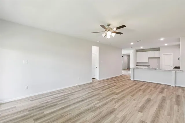 a view of an empty room with a kitchen