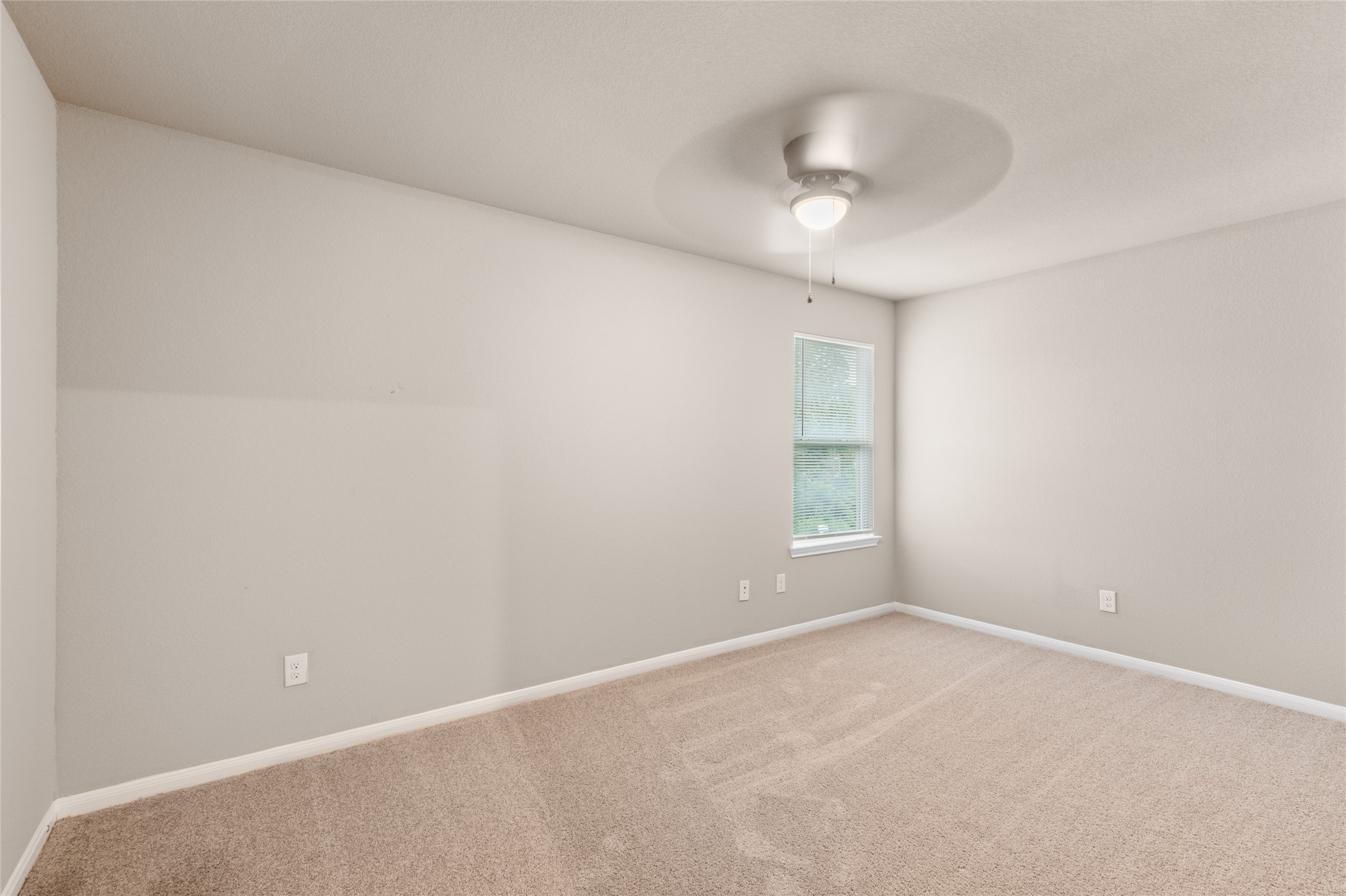 16630 East Hammon Montgomery, TX 77316 - Photo 12 of 14 an empty room with a chandelier fan and windows