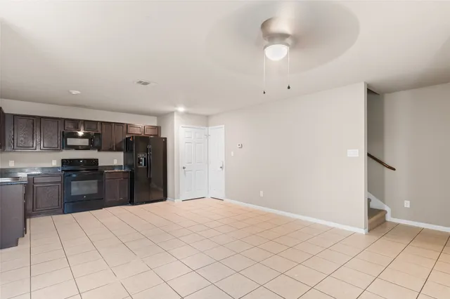 a kitchen with stainless steel appliances kitchen island granite countertop a refrigerator and a sink