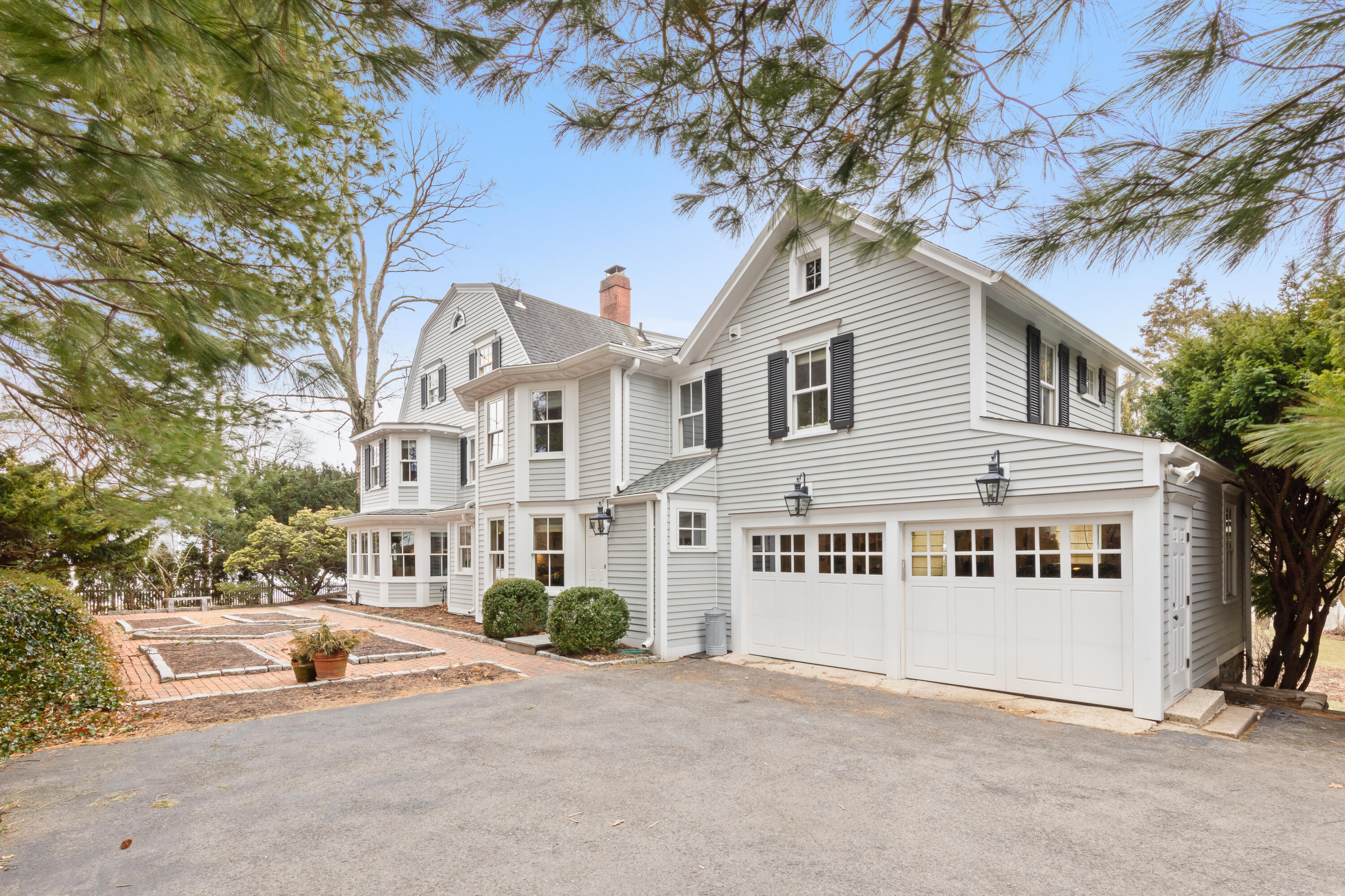 5 Middlesex Road Darien, CT 06820 - Photo 5 of 57 a view of a white house with a large tree and plants