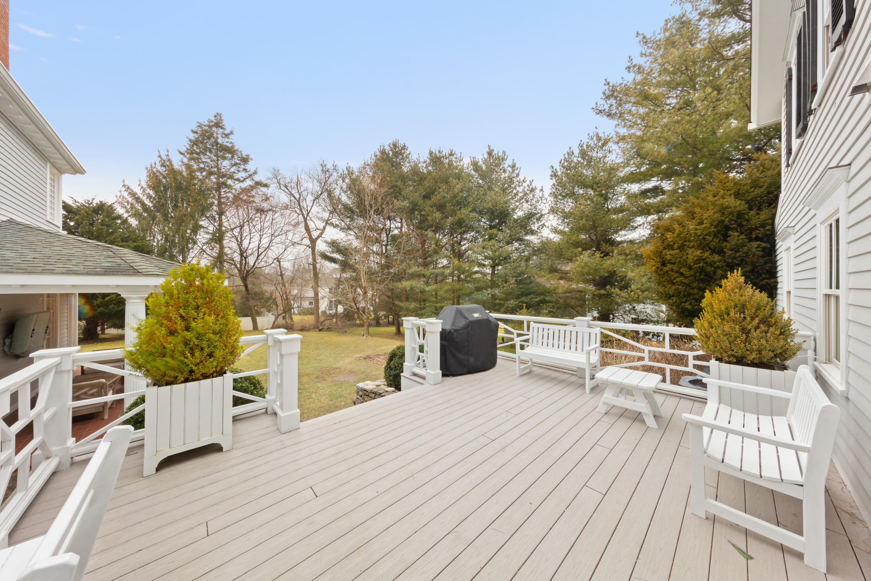 5 Middlesex Road Darien, CT 06820 - Photo 6 of 57 a view of a roof deck with table and chairs a barbeque with wooden floor and fence
