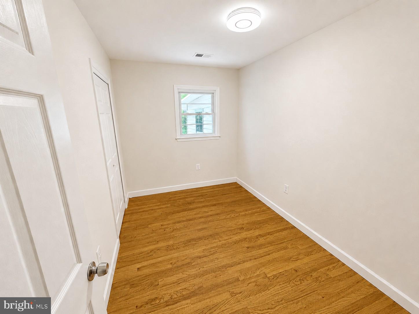 12658 Scaggsville Road Highland, MD 20777 - Photo 6 of 13 a view of a room with wooden floor and white walls