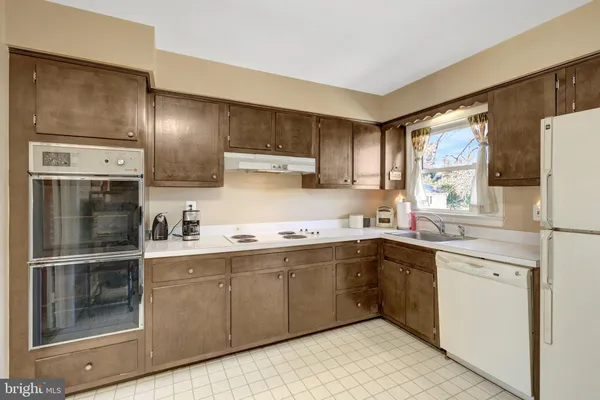 a kitchen with a sink stainless steel appliances and cabinets