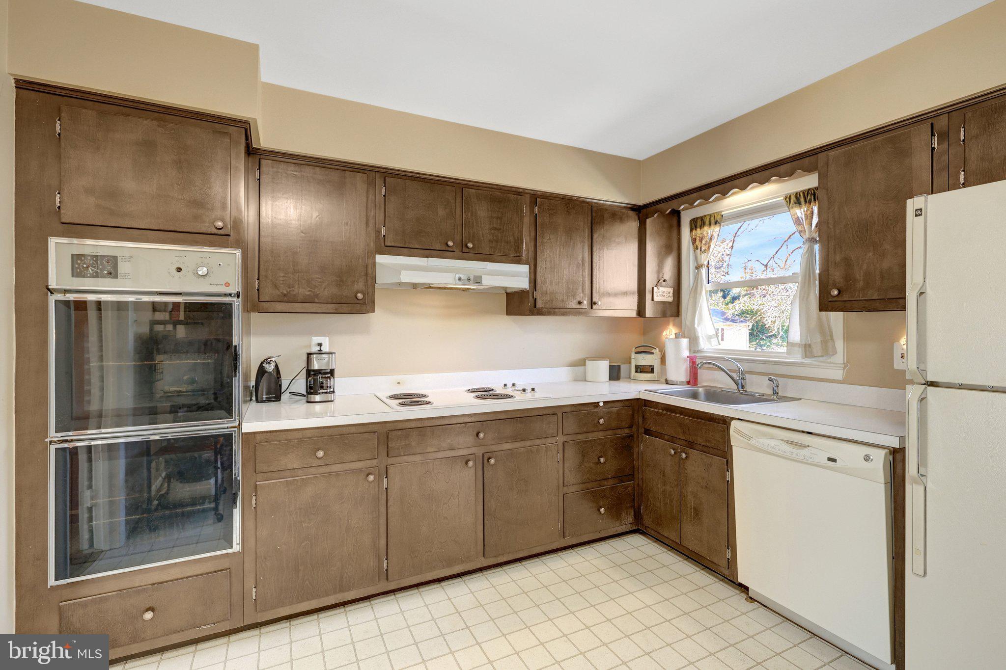 203 Locust Street Southwest Vienna, VA 22180 - Photo 13 of 54 a kitchen with a sink stainless steel appliances and cabinets