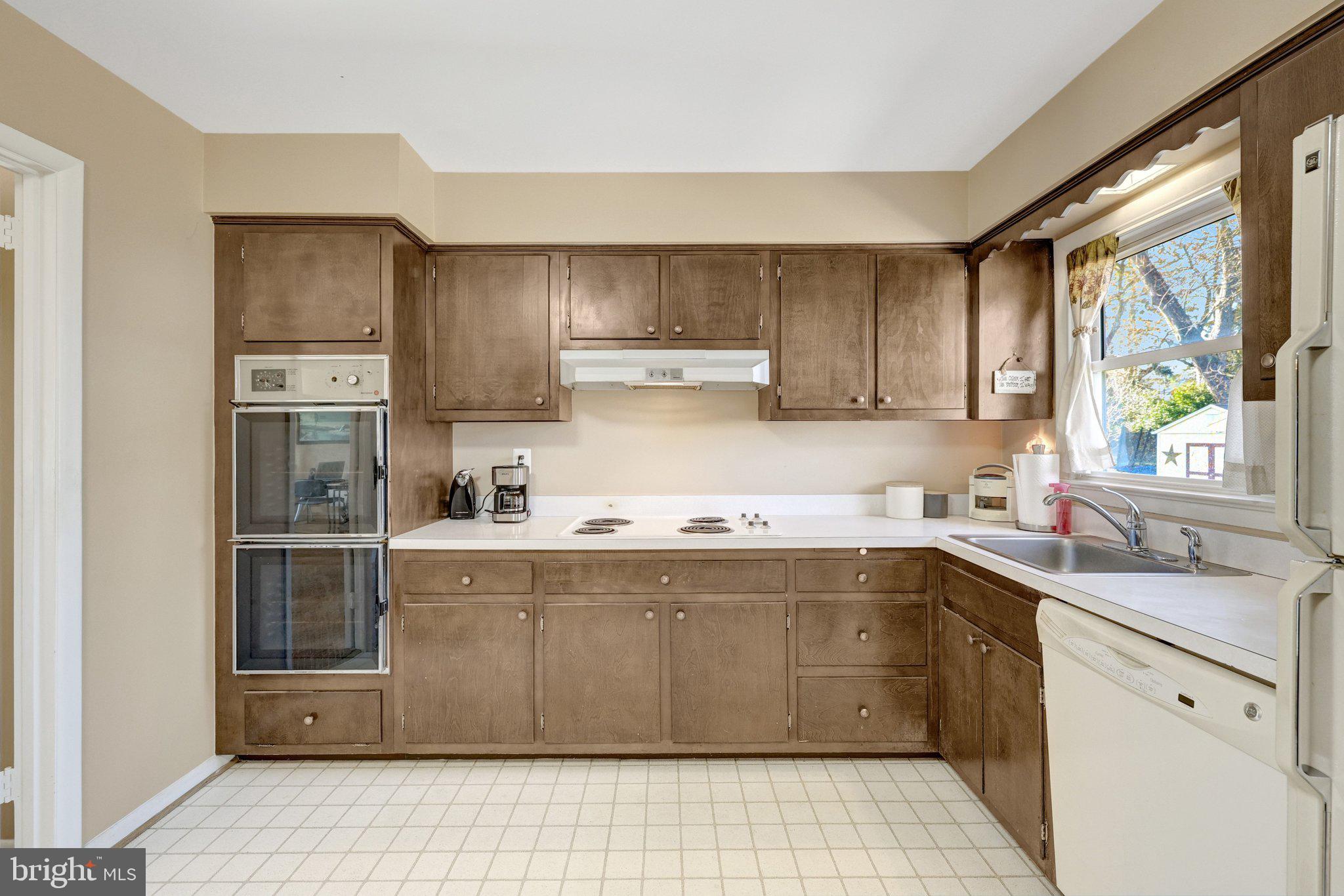 203 Locust Street Southwest Vienna, VA 22180 - Photo 15 of 54 a kitchen with stainless steel appliances a sink stove and refrigerator