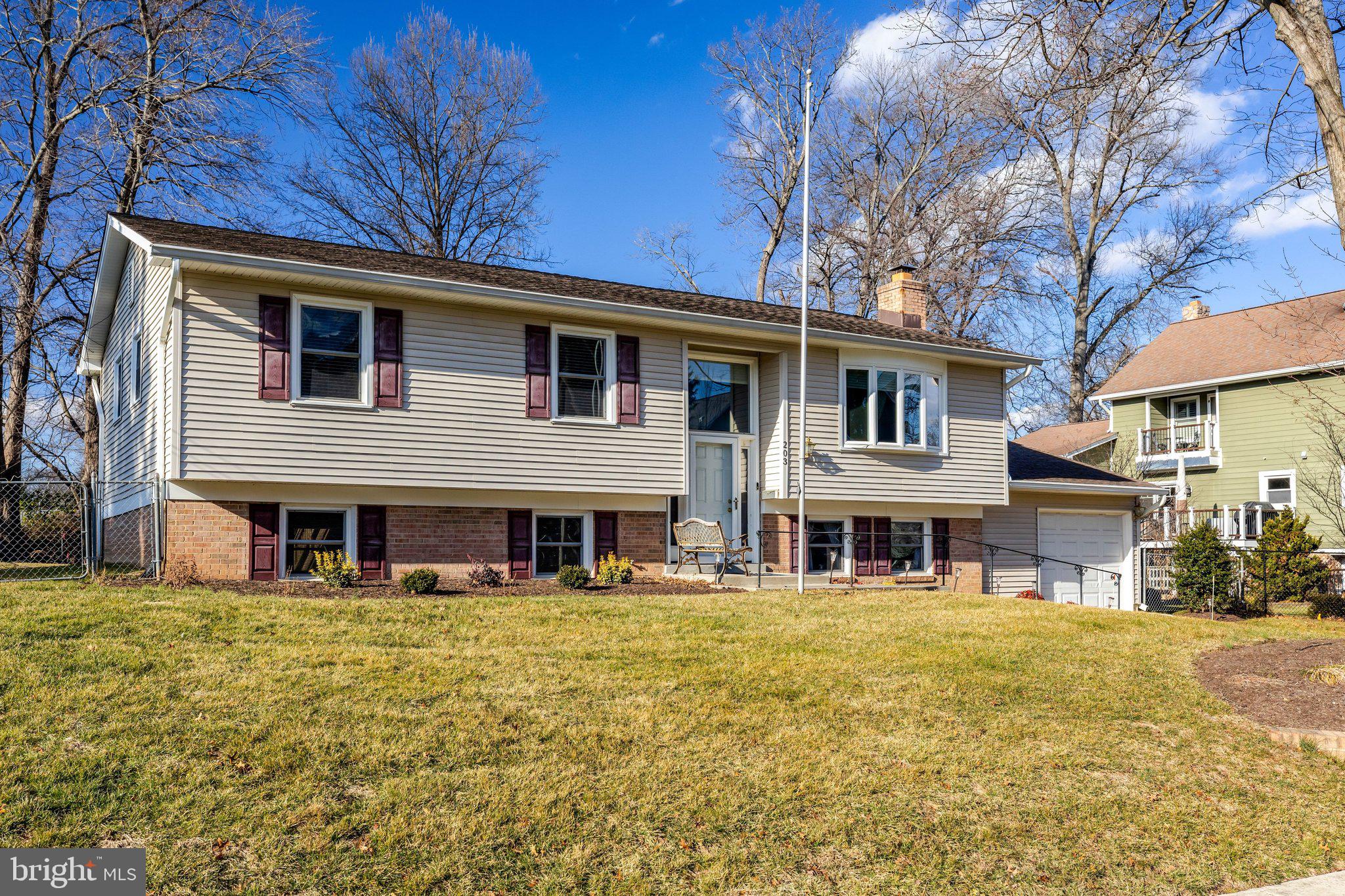 203 Locust Street Southwest Vienna, VA 22180 - Photo 2 of 54 a front view of a house with large windows