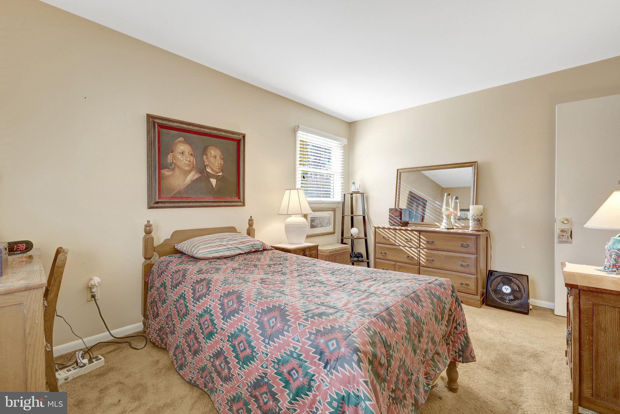 203 Locust Street Southwest Vienna, VA 22180 - Photo 21 of 54 a bedroom with a bed and dresser with mirror