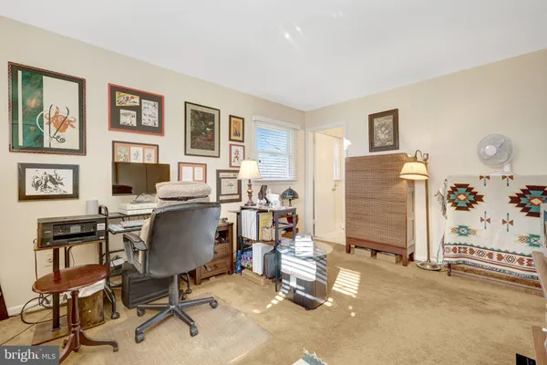 a view of a livingroom with workspace and a window