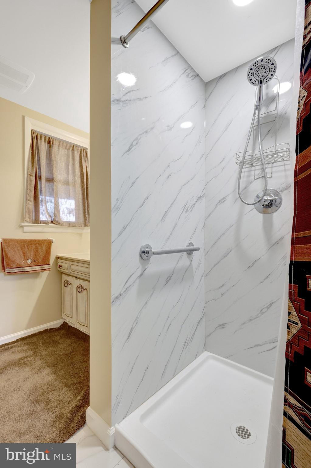 203 Locust Street Southwest Vienna, VA 22180 - Photo 26 of 54 a bathroom with a bathtub and a shower