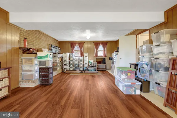 a view of a living room with furniture and wooden floor