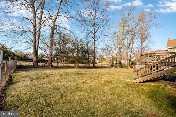 a view of a house with a big yard and sitting area