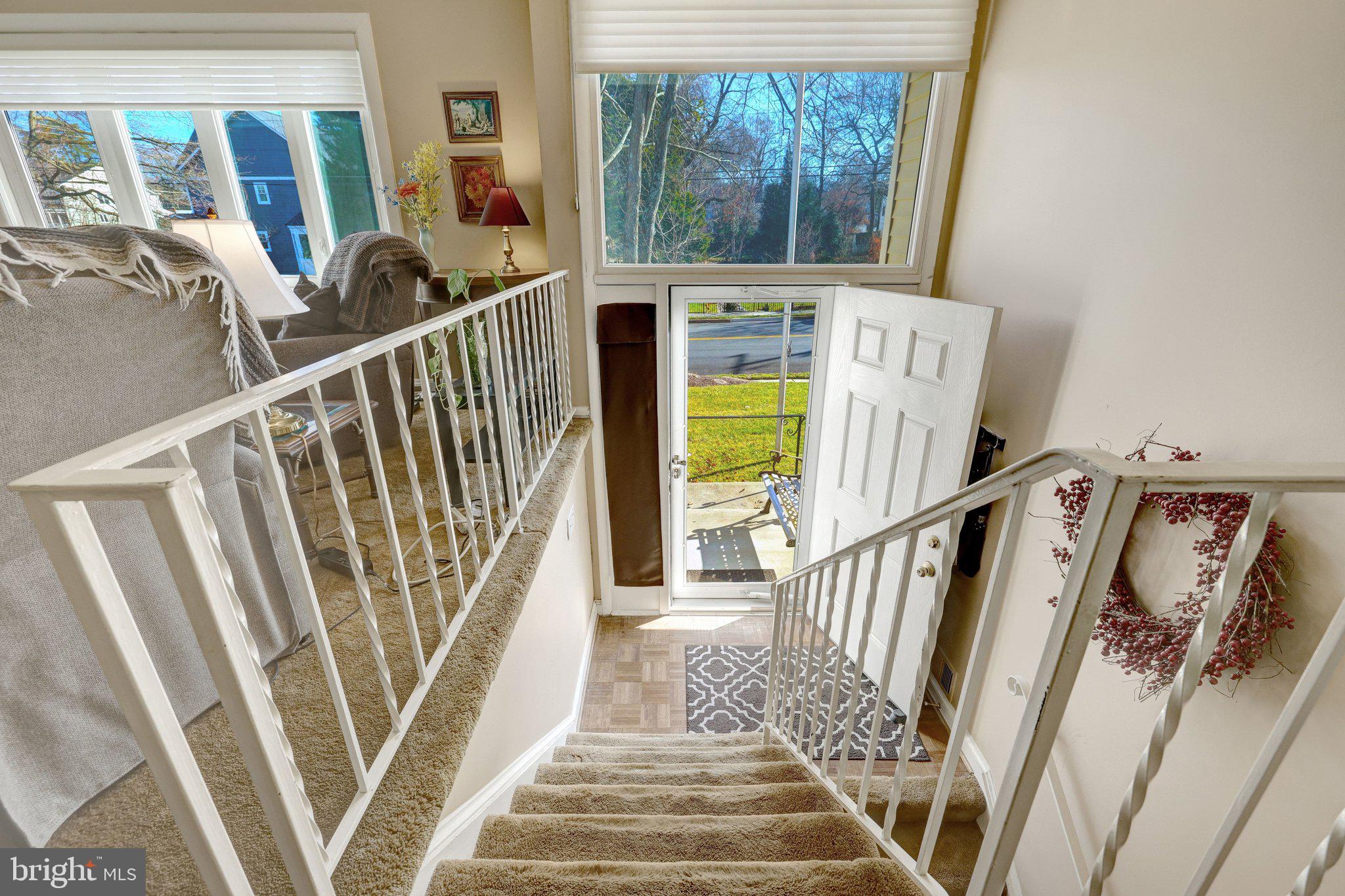 203 Locust Street Southwest Vienna, VA 22180 - Photo 5 of 54 a view of staircase with lots of frames on wall and a large window