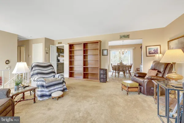a living room with furniture and a lamp