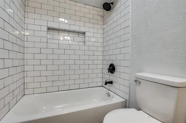 a bathroom with a bathtub and toilet