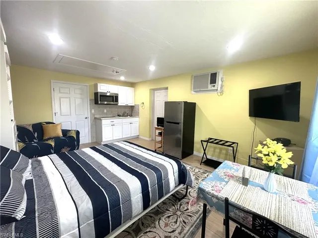a bedroom with a bed and a flat screen tv