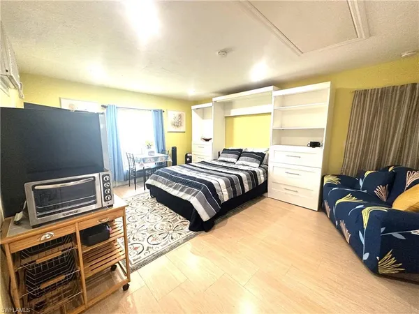 a bedroom with a bed and wooden floor