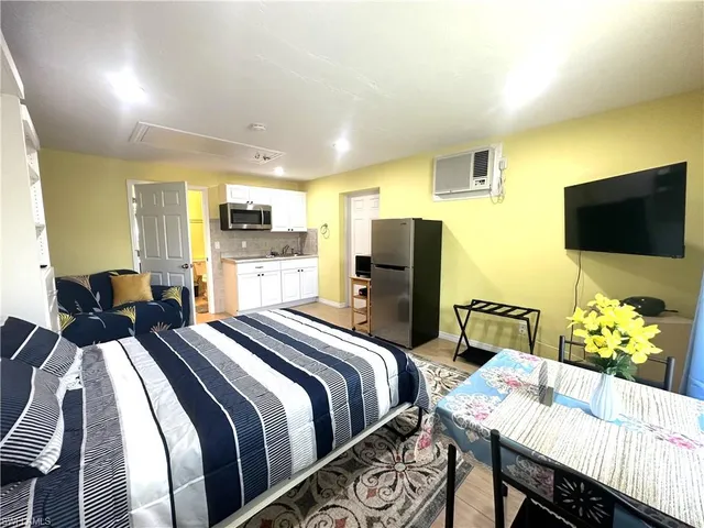 a bed room with a bed and a television