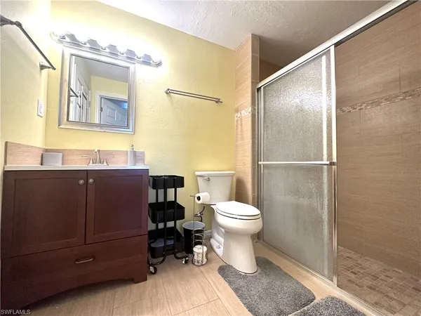 a bathroom with a toilet a sink and a mirror