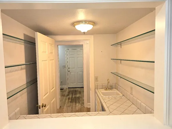 an empty room with windows and fireplace