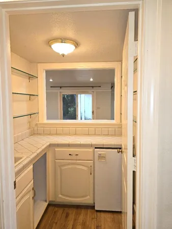 a view of a room with wooden floor and a window
