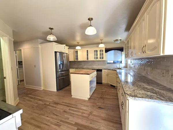 a kitchen with a sink stove and cabinets