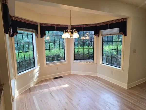 a large kitchen with cabinets and wooden floor