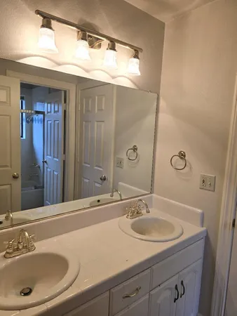 a view of an empty room with cabinet and a window
