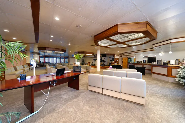 a living room with lots of furniture and clutter