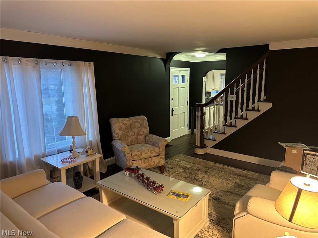 3192 Mogadore Road Akron, OH 44312 - Photo 15 of 43 Living area featuring arched walkways and wood finished floors