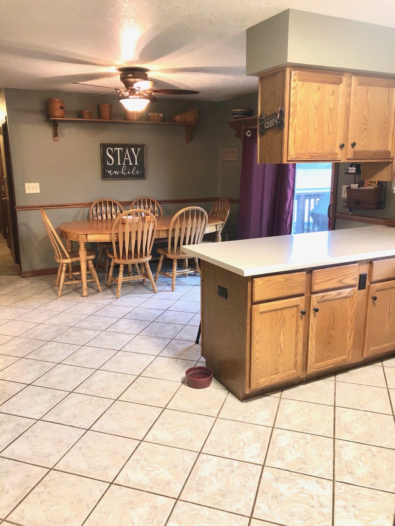 1894 Paulsen Road Dixon, IL 61021 - Photo 8 of 31 a open kitchen with a sink a counter and chairs