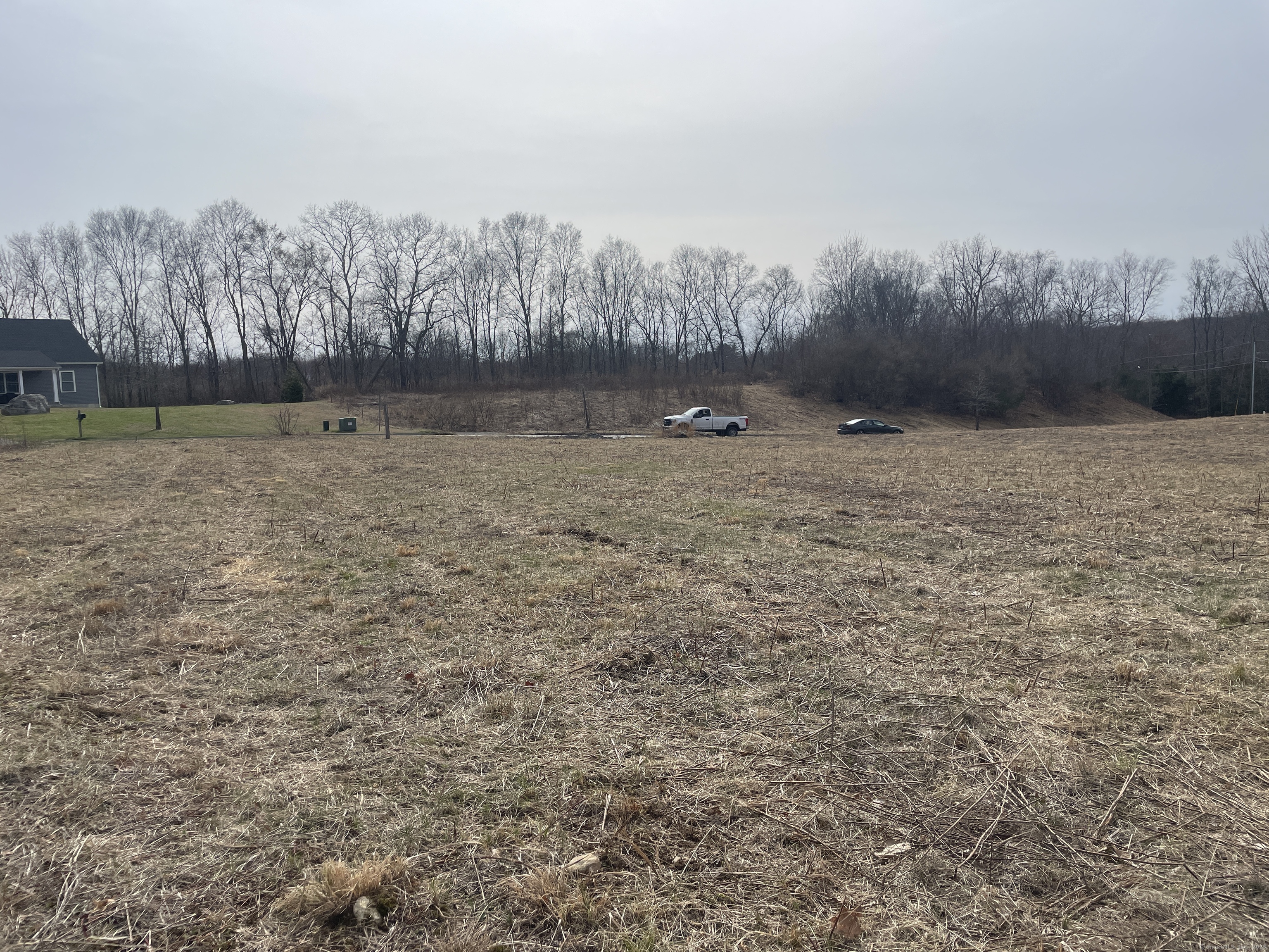 8 Harvest Road Lisbon, CT 06351 - Photo 3 of 5 a view of a dry yard with trees in the background