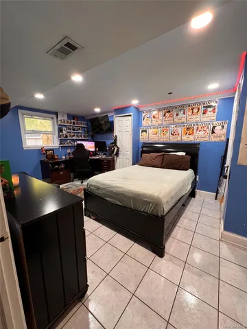 a bedroom with double bed and a large window